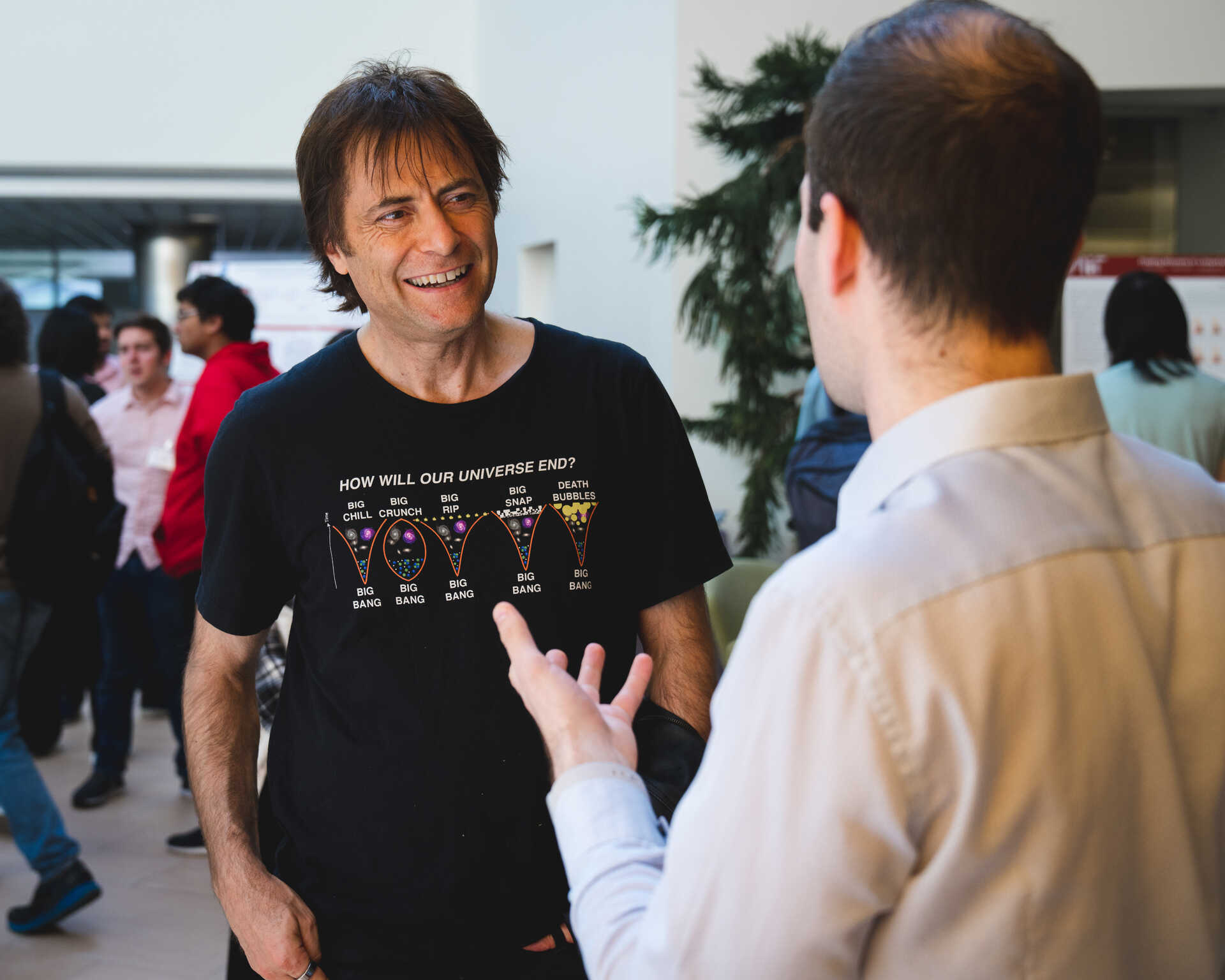 Max Tegmark standing in conversation